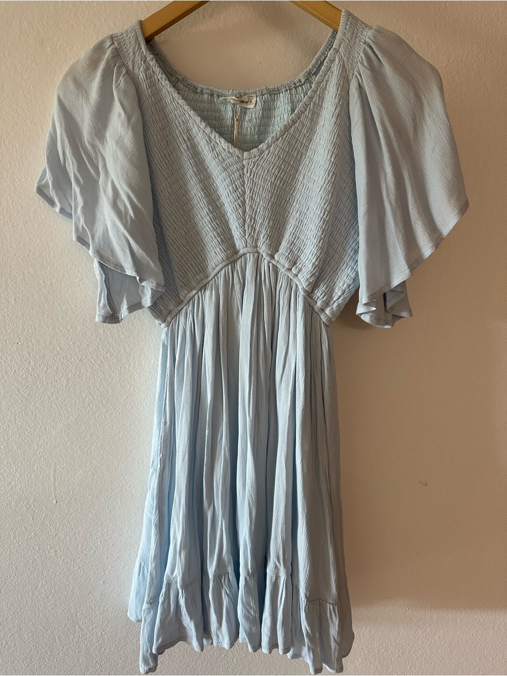 In loom light blue short-sleeved mini dress small V-neck smocked front.